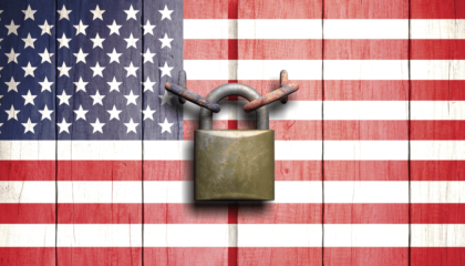 Symbolizing Hope: American flag backdrop with a central padlock - Understanding Asylum Law, a Beacon of Hope in Troubled Times by Ochoa & Hill Law Group, PLLC.